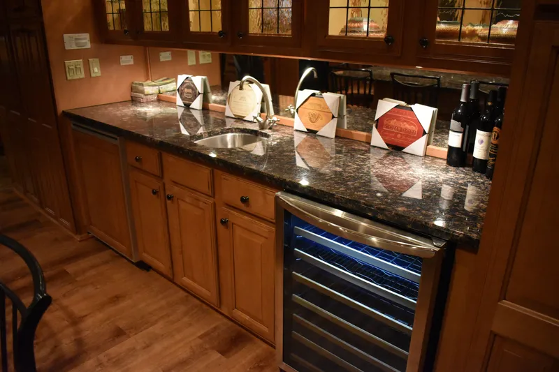 Slide: The Image of 2006 Sumerset Double Dippin kitchen with granite countertop, wine cooler, and wooden cabinets. - 13