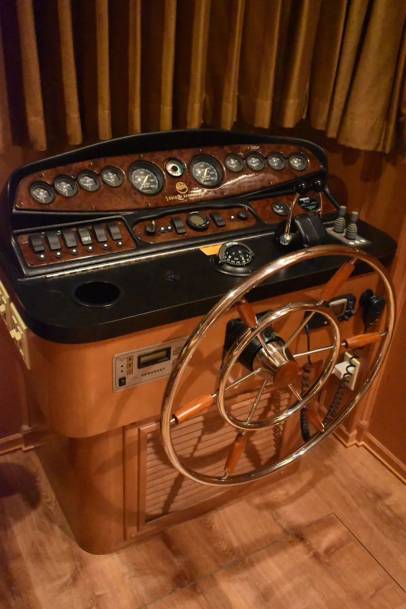 Slide: The Image of Helm of 2006 Sumerset Double Dippin houseboat with wooden dashboard and steering wheel. - 17
