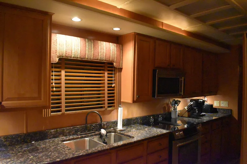 Slide: The Image of 2006 Sumerset Double Dippin kitchen with granite countertops and wooden cabinets. - 18