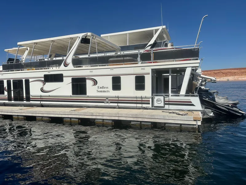 Slide: The Image of 2006 Sumerset Double Dippin houseboat docked on a sunny day. - 2