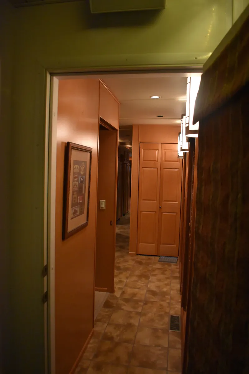 Slide: The Image of Interior hallway of 2006 Sumerset Double Dippin houseboat with wood paneling and tiled floor. - 20