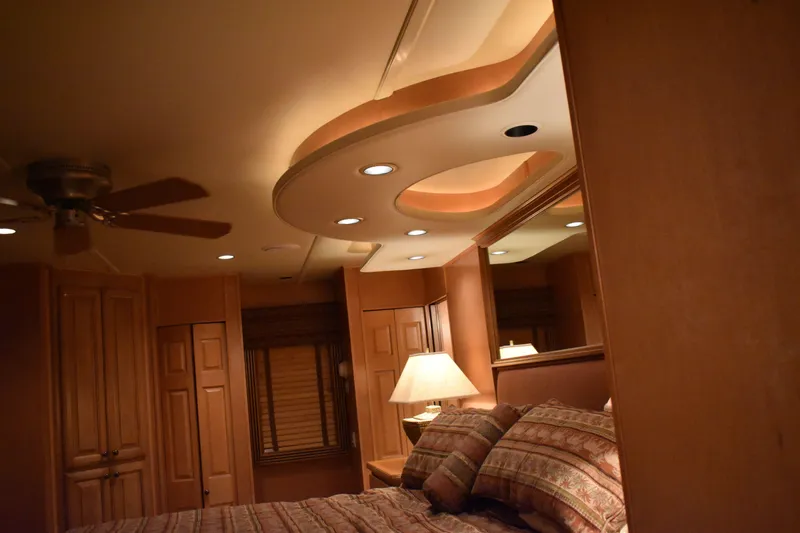 Slide: The Image of Luxurious bedroom interior of 2006 Sumerset Double Dippin houseboat with elegant lighting and wooden decor. - 25