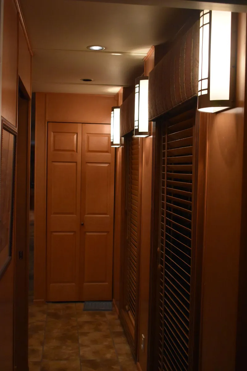 Slide: The Image of 2006 Sumerset Double Dippin houseboat interior hallway with wooden doors and modern lighting. - 31