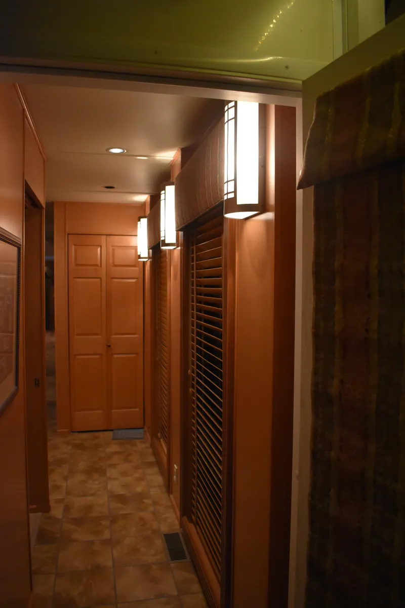 Slide: The Image of 2006 Sumerset Double Dippin houseboat interior hallway with wooden doors and modern lighting. - 33