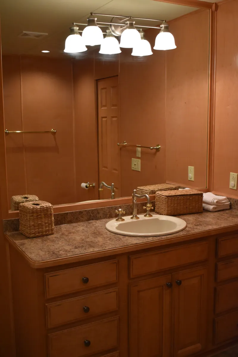 Slide: The Image of 2006 Sumerset Double Dippin bathroom with wooden cabinets and vanity mirror. - 38