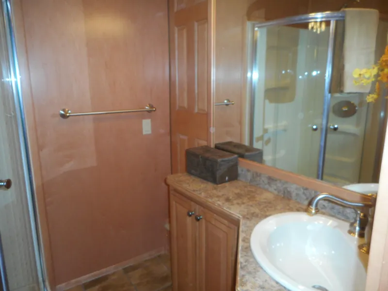 Slide: The Image of 2006 Sumerset Double Dippin houseboat bathroom with sink, mirror, and shower. - 39