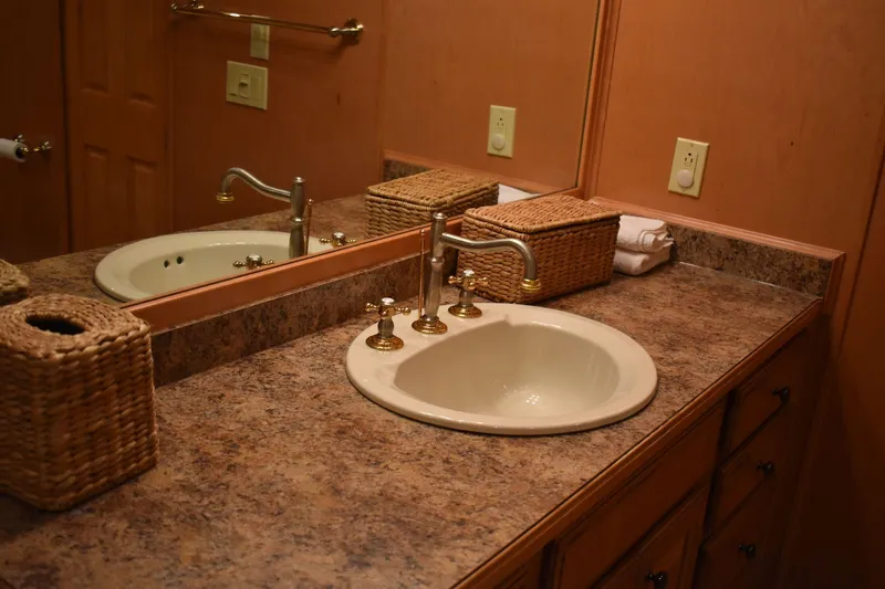 Slide: The Image of 2006 Sumerset Double Dippin bathroom sink with marble countertop and wicker accessories. - 41