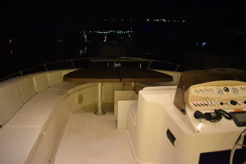 Slide: The Image of 2006 Sumerset Double Dippin boat deck at night with seating and control panel. - 45
