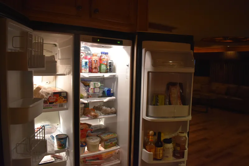 Slide: The Image of Open refrigerator in 2006 Sumerset Double Dippin houseboat, stocked with various food items. - 46