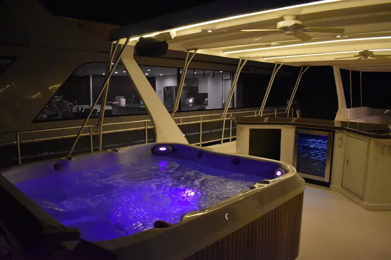 Slide: The Image of Luxurious 2006 Sumerset Double Dippin houseboat with illuminated hot tub at night. - 47