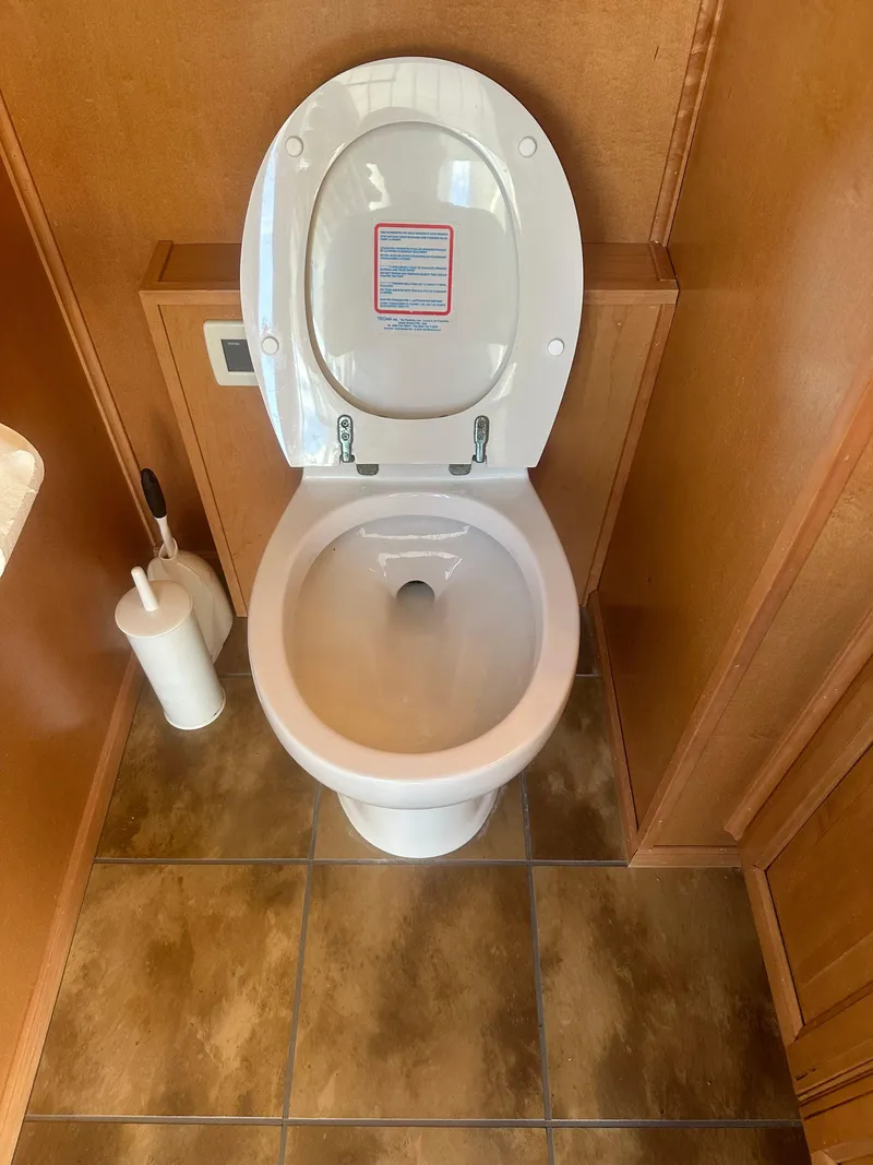 Slide: The Image of 2006 Sumerset Double Dippin houseboat bathroom with toilet and tile flooring. - 49