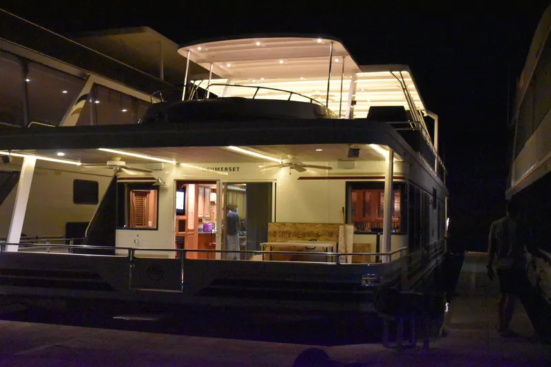 Slide: The Image of 2006 Sumerset Double Dippin houseboat illuminated at night, docked. - 6