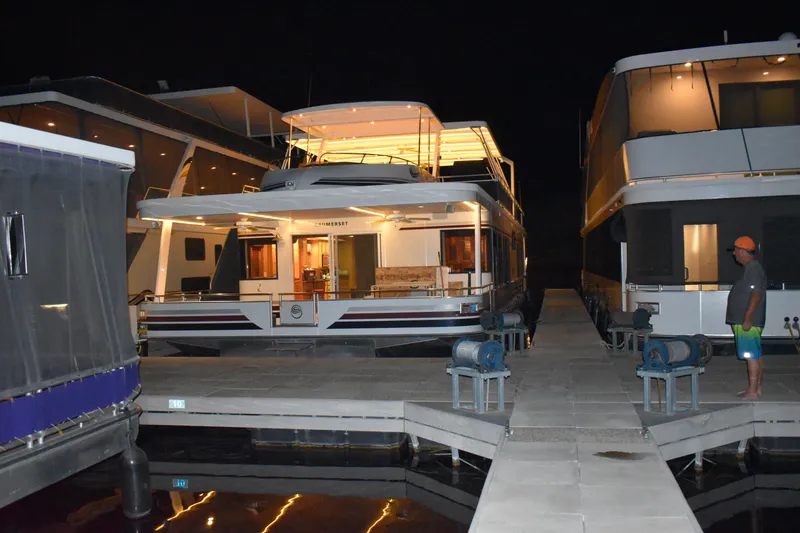 Slide: The Image of Sumerset Double Dippin 2006 houseboat docked at night with illuminated upper deck. - 7
