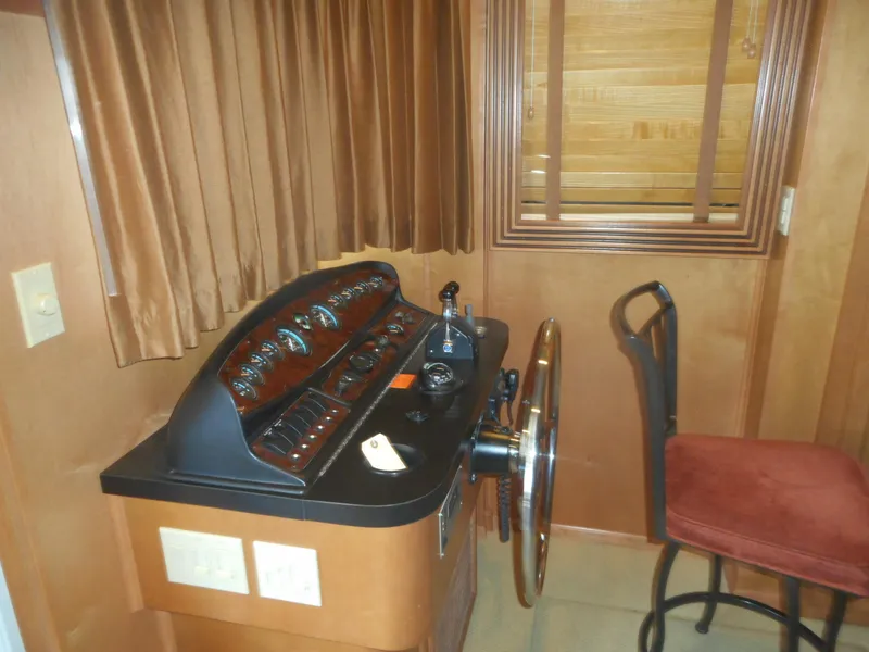Slide: The Image of 2006 Sumerset Double Dippin houseboat helm station with control panel and captain's chair. - 9