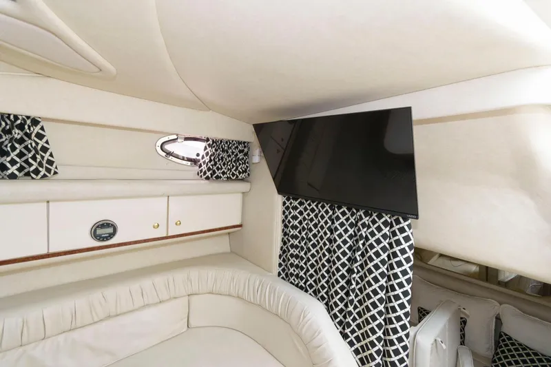 Slide: The Image of Interior cabin of a 1997 Sea Ray 330 Sundancer with TV and patterned curtains. - 10