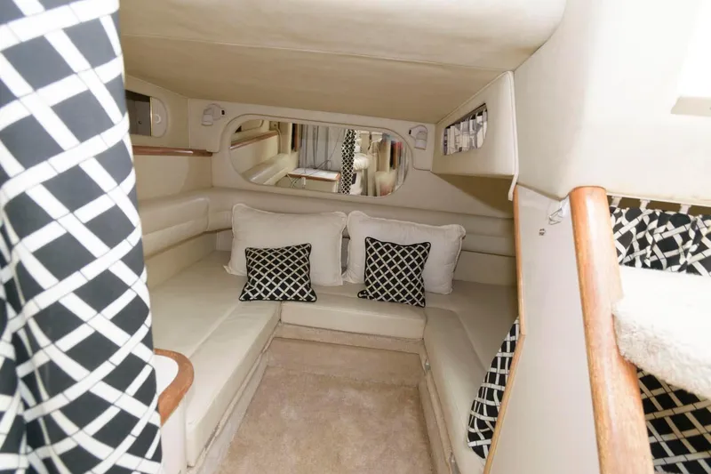 Slide: The Image of Interior cabin of 1997 Sea Ray 330 Sundancer with beige seating and patterned cushions. - 12