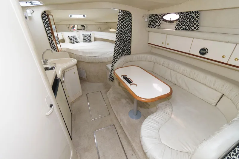 Slide: The Image of 1997 Sea Ray 330 Sundancer cabin interior with seating, table, and bed. - 7