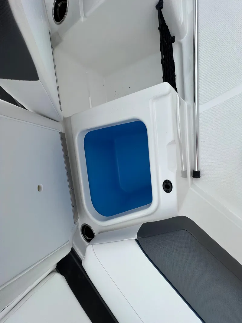 Slide: The Image of 2024 Tahoe 210 S boat interior storage compartment with blue liner. - 11