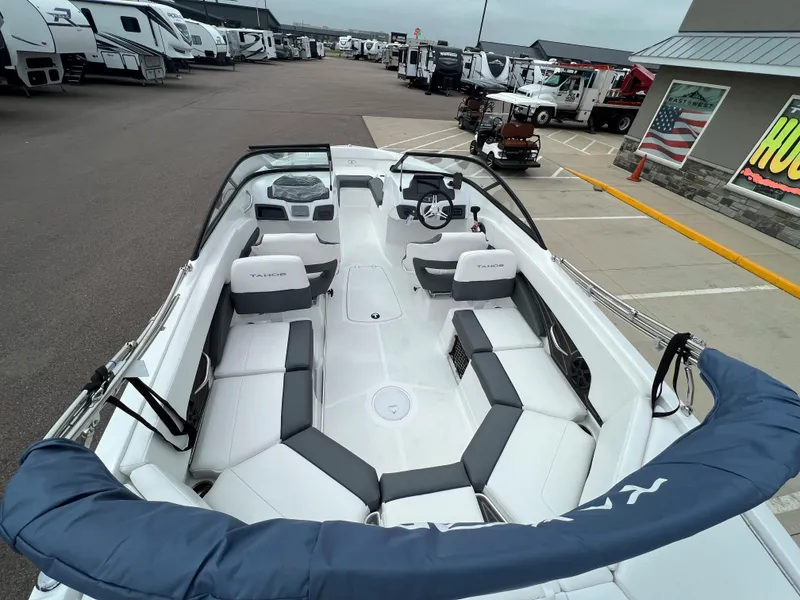 Slide: The Image of 2024 Tahoe 210 S boat interior at dealership, showcasing seating and dashboard. - 15