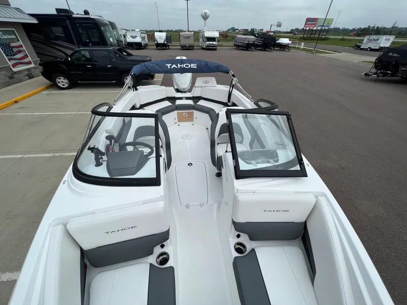 Slide: The Image of 2024 Tahoe 210 S boat with open cockpit and windshield in parking lot. - 16