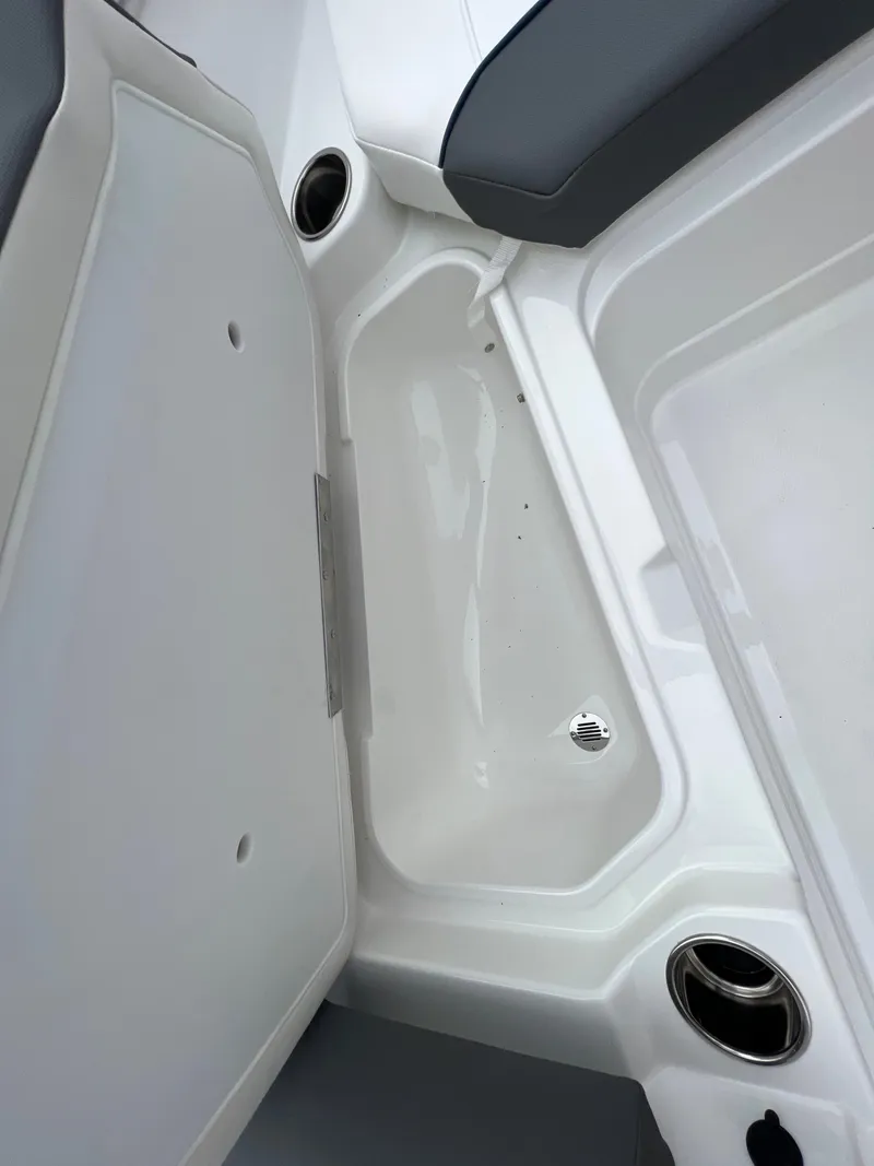 Slide: The Image of 2024 Tahoe 210 S boat interior storage compartments and cup holders. - 4