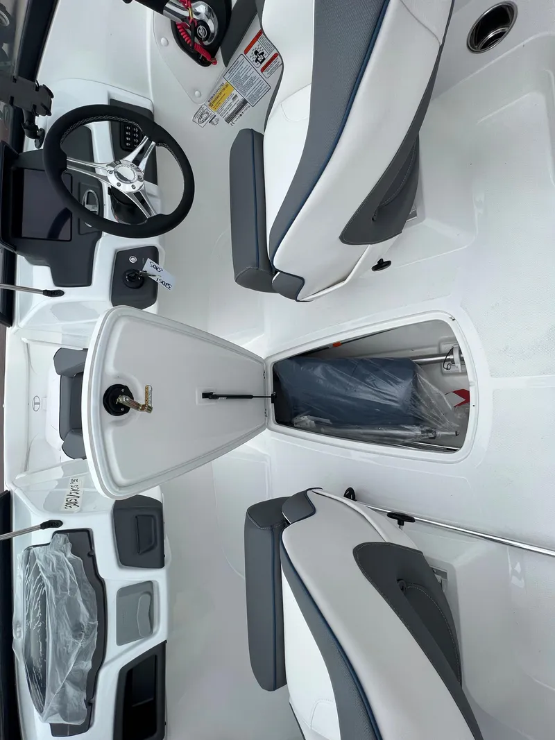 Slide: The Image of 2024 Tahoe 210 S boat interior with storage compartment open. - 6