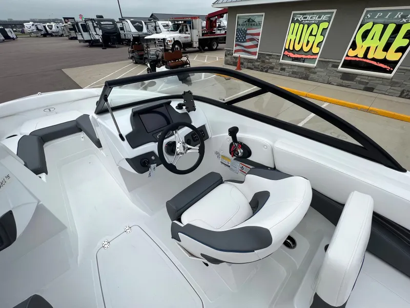 Slide: The Image of 2024 Tahoe 210 S boat interior with steering wheel and seating. - 7