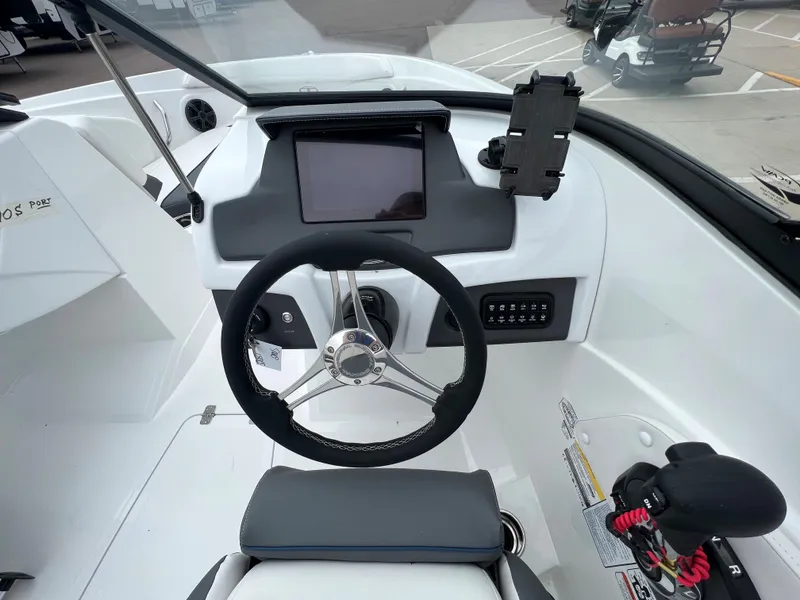 Slide: The Image of 2024 Tahoe 210 S boat dashboard with steering wheel and touchscreen display. - 8