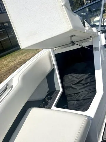 Slide: The Image of 2021 Cobalt R7 Surf boat interior with white leather seats and gray flooring. - 19