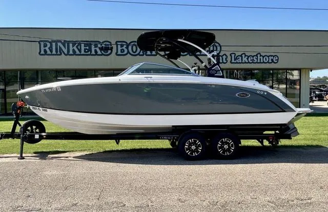 Slide: The Image of 2021 Cobalt R7 Surf boat on trailer outside Rinker's Boat World. - 2