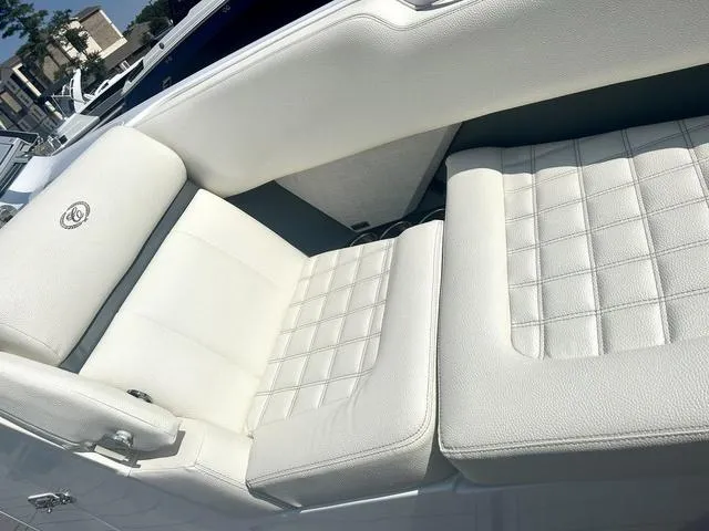 Slide: The Image of 2021 Cobalt R7 Surf boat with open storage compartment and white seating. - 20