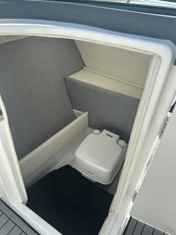 Slide: The Image of Interior of a 2021 Cobalt R7 Surf boat with gray and white seating. - 32