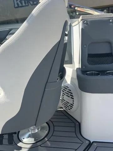 Slide: The Image of 2021 Cobalt R7 Surf boat interior with white cushioned seating and gray flooring. - 42