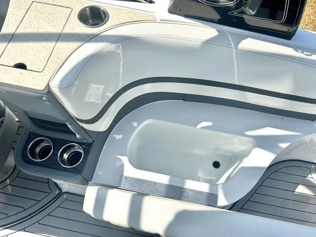 Slide: The Image of 2021 Cobalt R7 Surf boat interior with seating, cup holders, and storage compartments. - 44