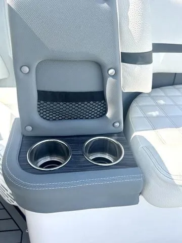 Slide: The Image of Open storage compartment in 2021 Cobalt R7 Surf boat with cup holders. - 46
