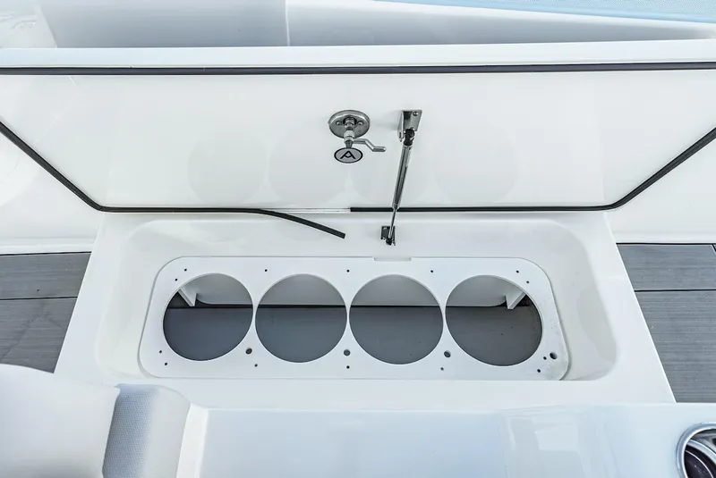 Slide: The Image of 2024 Aviara AV 32 boat storage compartment with circular holders. - 13