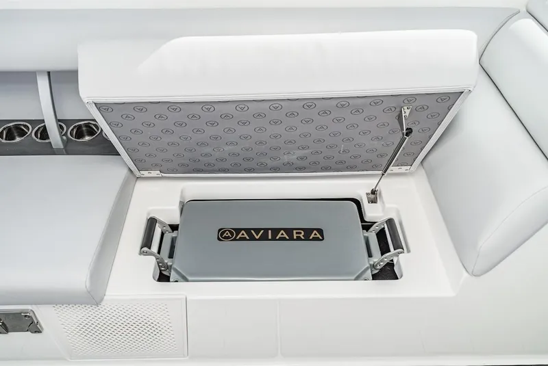 Slide: The Image of 2024 Aviara AV 32 boat storage compartment with branded cooler. - 19