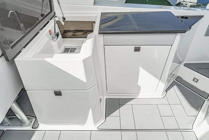 Slide: The Image of 2024 Aviara AV 32 boat interior with sleek white cabinetry and modern countertop. - 21