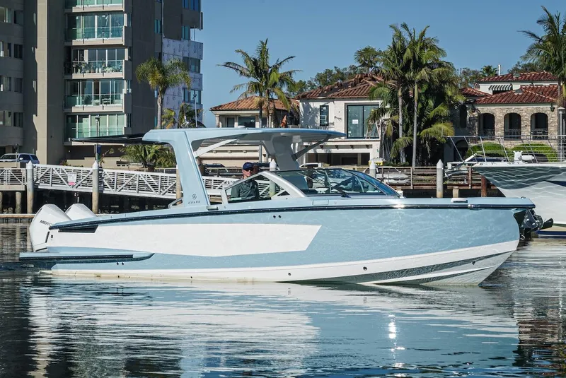 Slide: The Image of 2024 Aviara AV 32 boat docked near waterfront buildings and palm trees. - 3