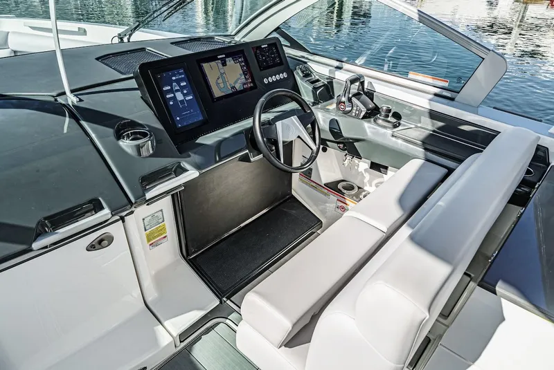 Slide: The Image of 2024 Aviara AV 32 boat cockpit with modern navigation system and luxurious seating. - 31