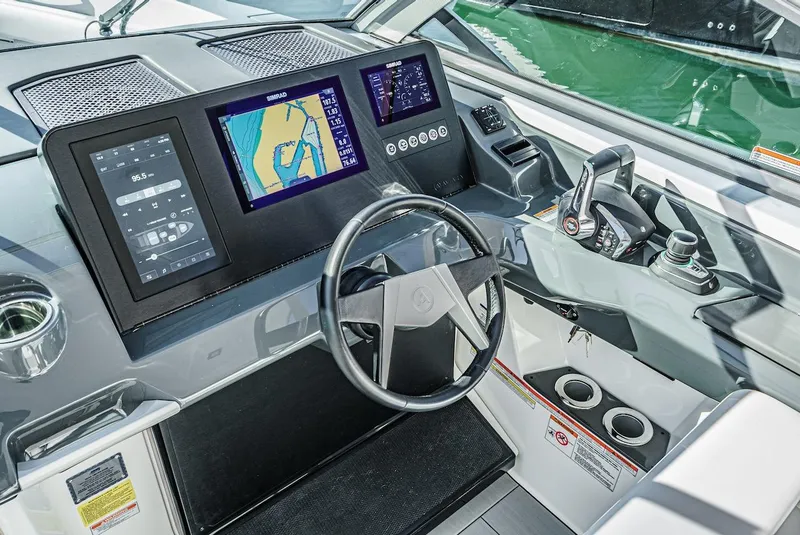 Slide: The Image of 2024 Aviara AV 32 boat cockpit with advanced navigation system and modern controls. - 32