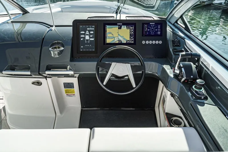 Slide: The Image of 2024 Aviara AV 32 boat helm with modern navigation displays and controls. - 34