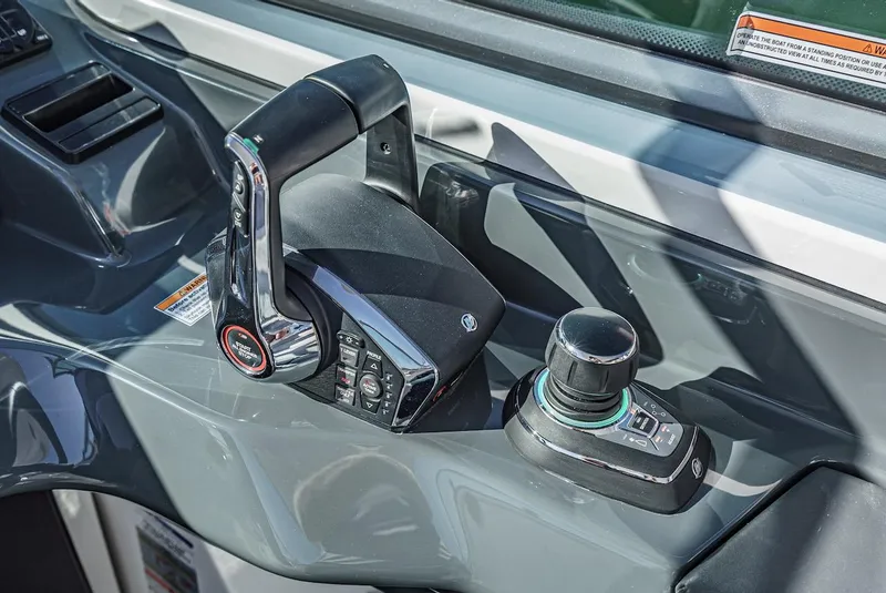 Slide: The Image of 2024 Aviara AV 32 boat control panel with throttle and joystick. - 36