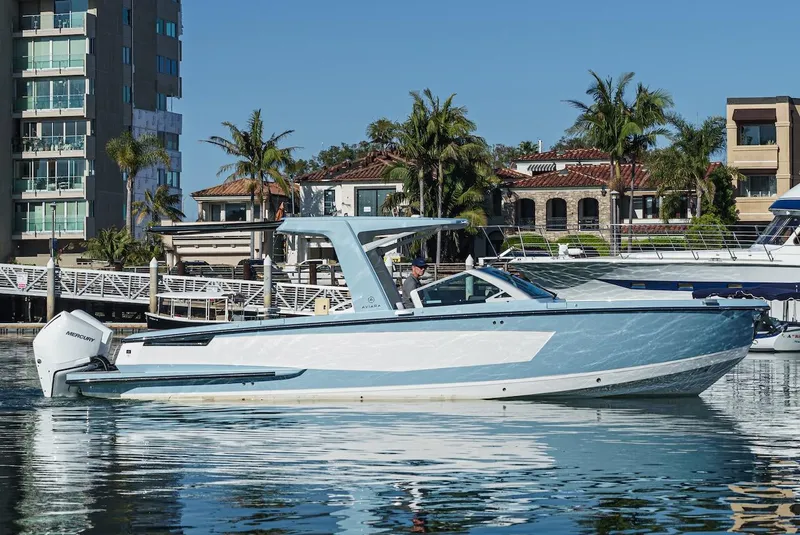 Slide: The Image of 2024 Aviara AV 32 boat docked in a marina with waterfront homes in the background. - 4