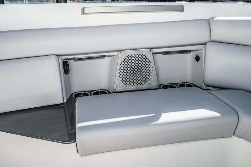 Slide: The Image of Interior seating of 2024 Aviara AV 32 boat with integrated speaker and cup holders. - 43
