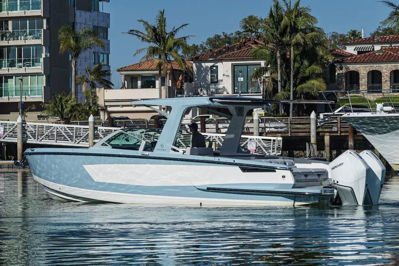 Slide: The Image of 2024 Aviara AV 32 boat docked in a marina with waterfront homes in the background. - 6