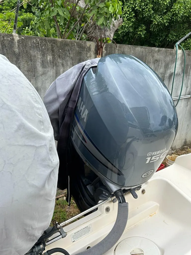 Slide: The Image of Outboard motor on a 2012 Pursuit 255 boat, Yamaha 150 engine, outdoor setting. - 3