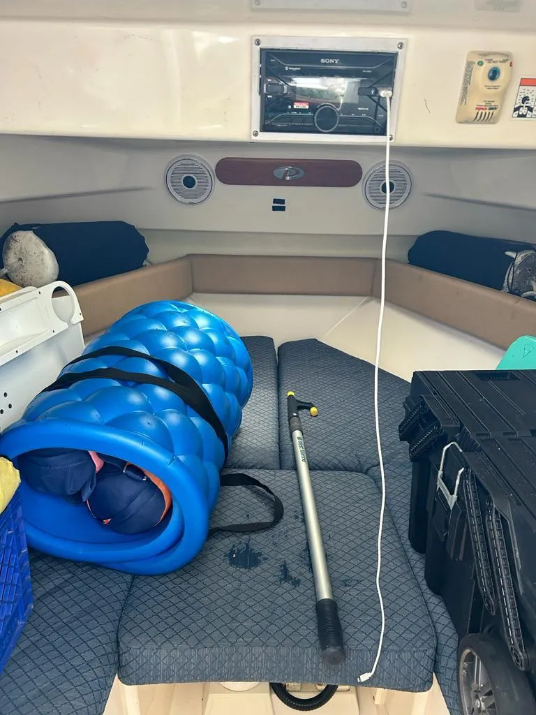 Slide: The Image of Interior of a 2012 Pursuit 255 boat with gear and equipment. - 6