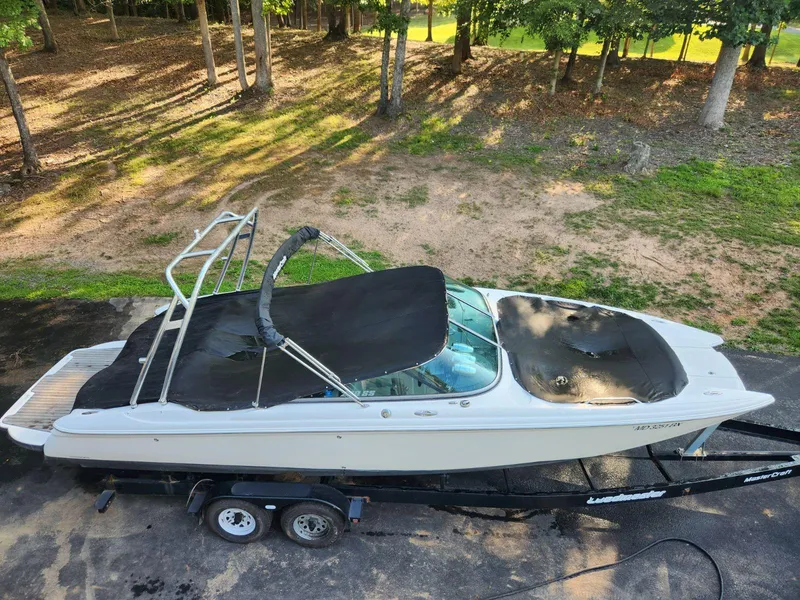 Slide: The Image of 2006 MasterCraft 280 SST boat on a trailer in a wooded area. - 3