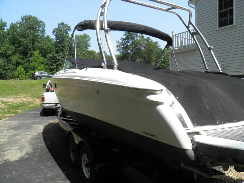 Slide: The Image of 2006 MasterCraft 280 SST boat on trailer, covered and parked in driveway. - 7